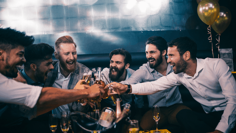 What Does A Best Man Do? 2 Friends celebrating with drinks and laughter.