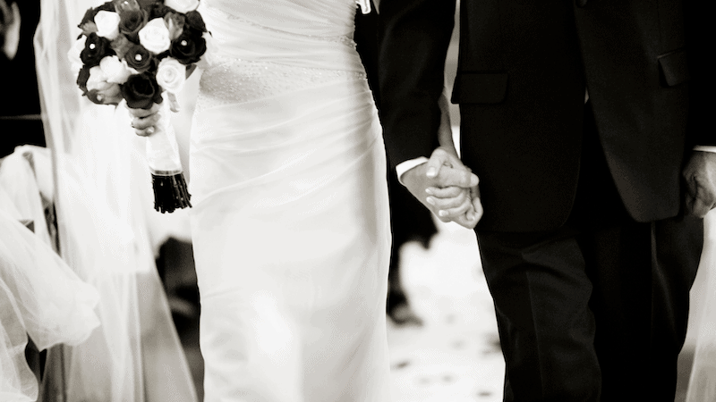 How To Plan Your Wedding Ceremony Seating 2 Close-up of a Bride and Groom holding hands