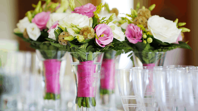 How Much Do Wedding Flowers Cost (10 Tips How To Save) 4 Four glass vases holding bridal and bridesmaids' bouquets