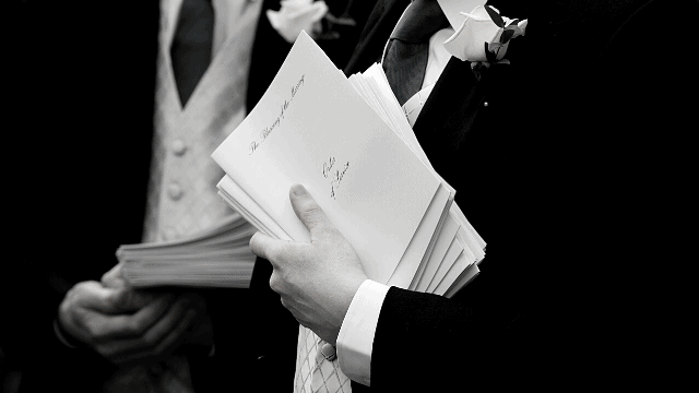 What Do Ushers Do at a Wedding? - The Ultimate Guide 2 ushers handing out programs