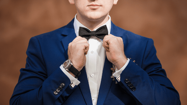 Wedding Planning For The Groom: The No-Stress Guide to Nailing Your Role! 2 Groom adjusting bow tie, formal attire