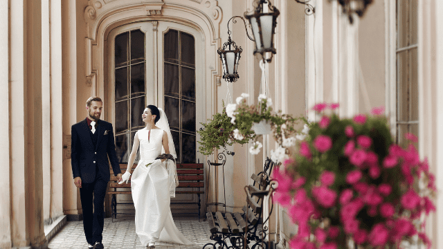 Wedding Planning For The Groom: The No-Stress Guide to Nailing Your Role! 3 Couple walking in elegant setting.