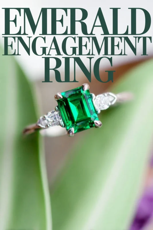 Non-Traditional Engagement Rings: Say Yes To A New Trend 5 Emerald engagement ring with rectangular green center stone and diamond side accents displayed against a soft botanical background