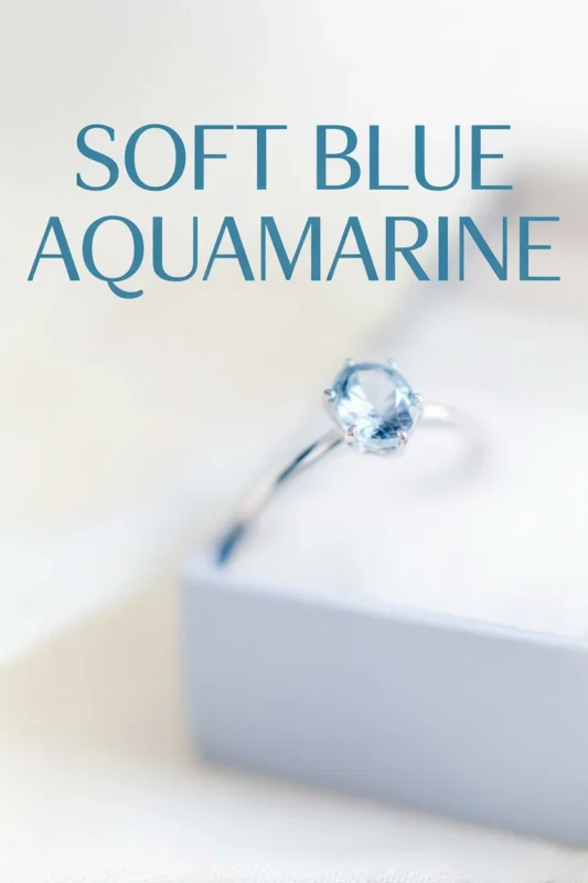 Non-Traditional Engagement Rings: Say Yes To A New Trend 4 Soft blue aquamarine engagement ring on a minimalist display box with light airy background and modern editorial styling