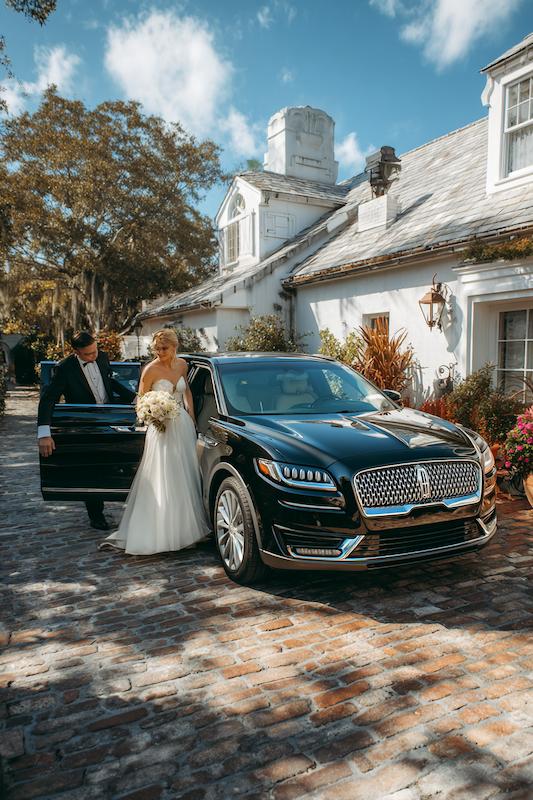 Bride arriving in luxury vehicle.