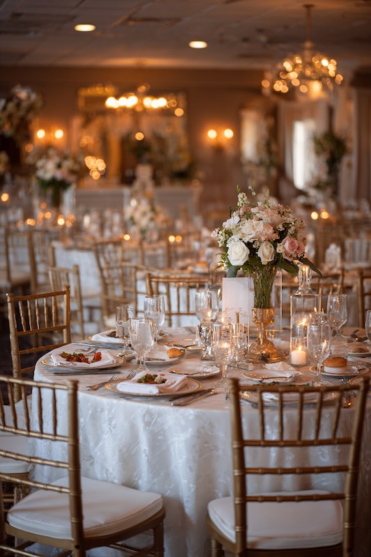 Elegant wedding reception with floral arrangements.