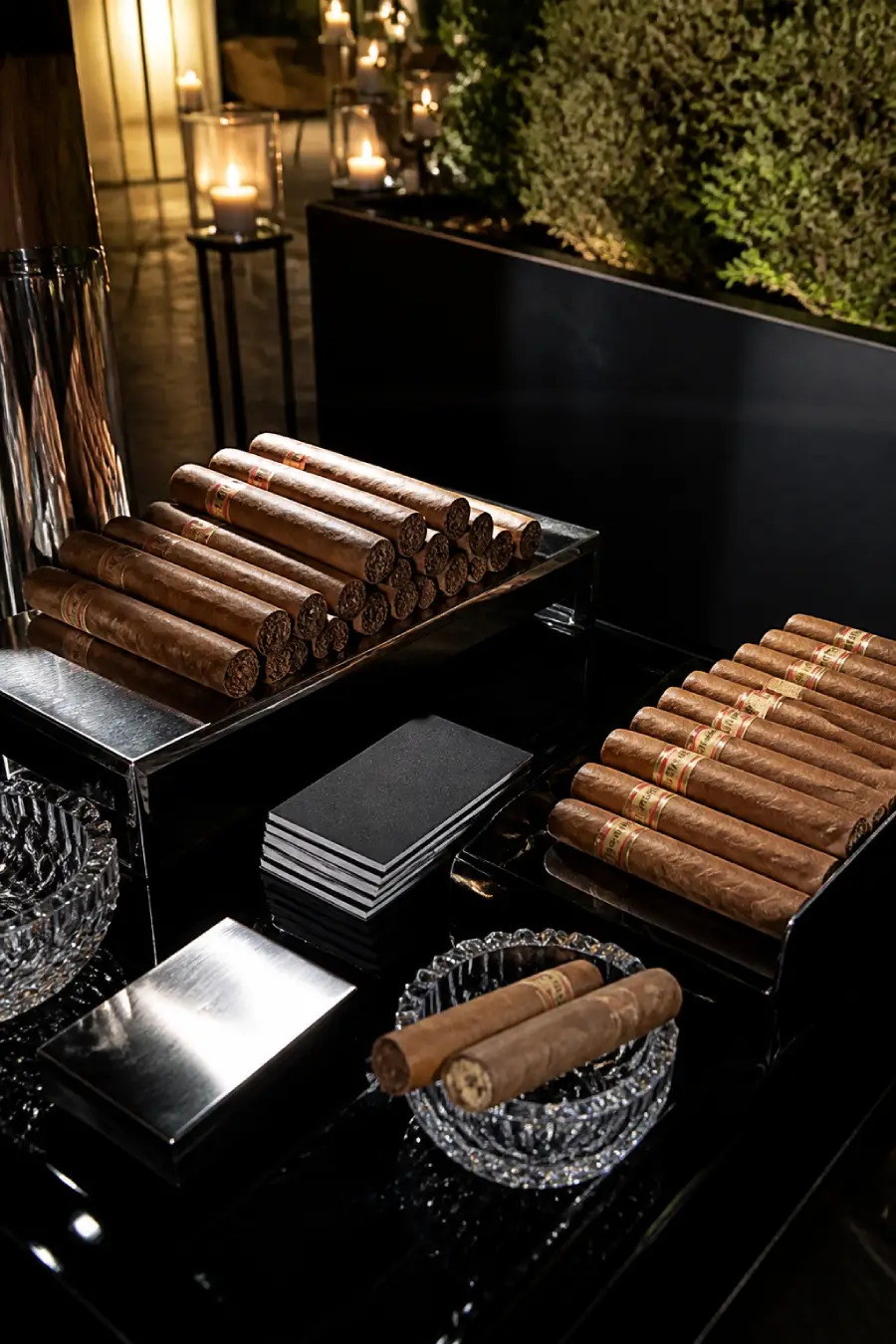 33 Jaw-Dropping Ways to Wow Your Wedding Guests at the Reception 12 Rows of premium cigars rest on black lacquer trays with crystal ashtrays and candles at an elegant wedding cigar bar at dusk.