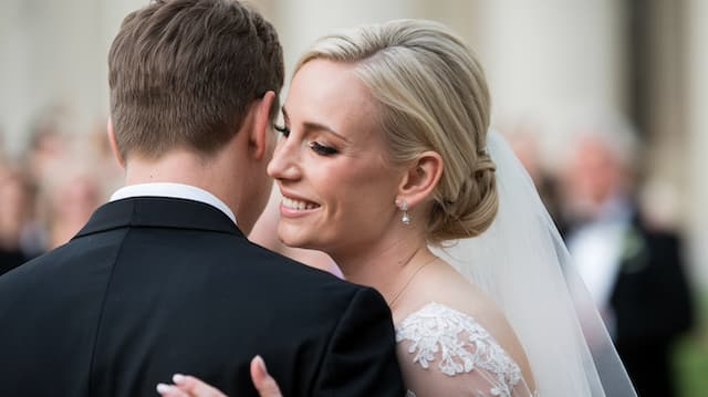 Bride Whispering to Groom Bride Smiling at Groom During Their First Dance, Sharing an Intimate Moment on Their Wedding Day.