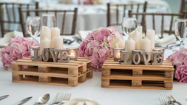 Mini Pallets Tablescape Rustic mini pallet centerpieces with pillar candles, metal LOVE letters, and pink hydrangeas on an elegant wedding tablescape.