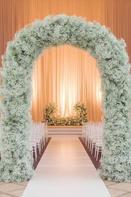 Baby's Breath Arch for a Dramatic Aisle Entrance Elegant wedding aisle adorned with a dramatic baby’s breath arch, creating a stunning floral entrance for the ceremony