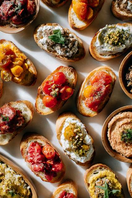 Bruschetta and Crostini Station A variety of bruschetta and crostini with assorted toppings arranged on a platter, showcasing vibrant and colorful appetizers.