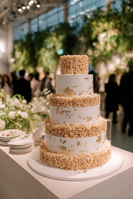 Rice Krispies tiered design weddign cake Rice Krispies wedding cake featuring alternating layers of white fondant accented with gold leaf and crispy rice cereal tiers, creating a playful yet elegant twist on a traditional wedding cake design