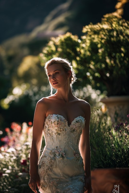 mermaid wedding dress with Sweetheart neckline A bride in a strapless mermaid wedding gown with intricate lace and floral embellishments, showcasing a soft, romantic look in an outdoor setting