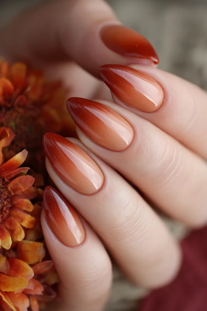 Burnt orange ombré almond-shaped nails with a warm gradient, set against a backdrop of autumn florals, perfect for fall weddings Burnt orange ombré almond-shaped nails with a warm gradient, set against a backdrop of autumn florals, perfect for fall weddings