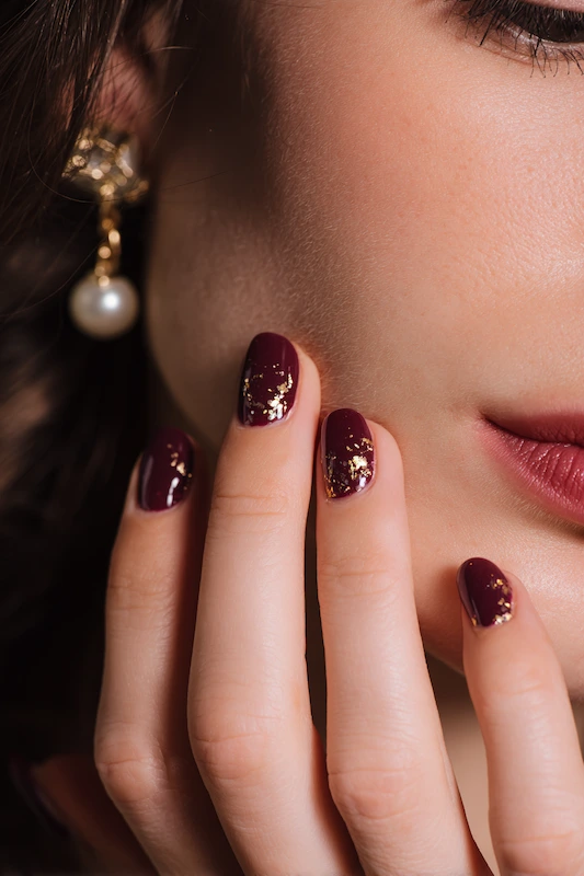 Deep wine nails with gold foil accents Deep wine nails with gold foil accents