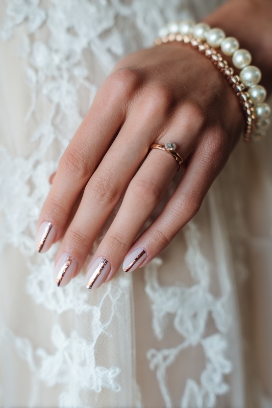 elegant almond nails featuring a muted taupe polish and one sleek copper foil line for a modern bridal touch elegant almond nails featuring a muted taupe polish and one sleek copper foil line for a modern bridal touch