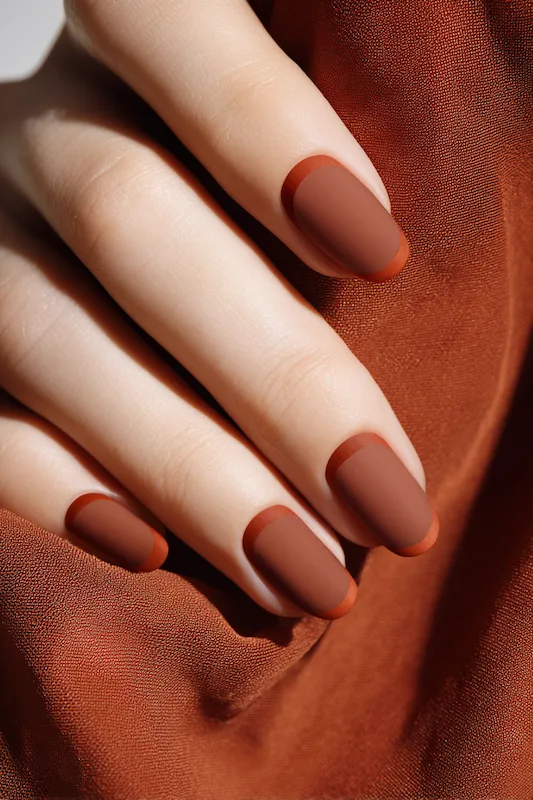 rich chestnut nails with a soft matte finish and a fine glossy arc hugging the cuticle for subtle elegance rich chestnut nails with a soft matte finish and a fine glossy arc hugging the cuticle for subtle elegance
