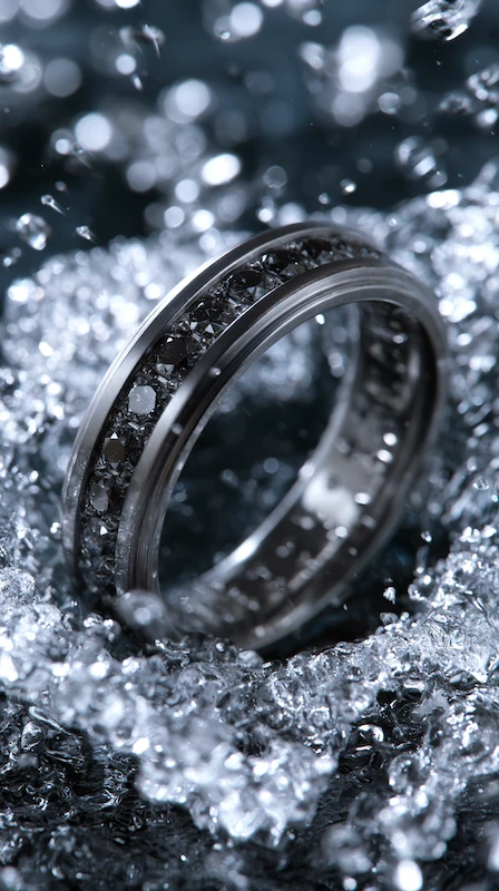 Black Diamond Wedding Rings for Men: Bold, Masculine, and Built to Last 4 Channel-set black diamond wedding band surrounded by sparkling ice crystals in a dramatic luxury close-up scene