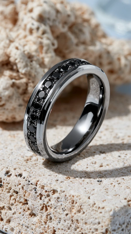 Black Diamond Wedding Rings for Men: Bold, Masculine, and Built to Last 1 Black diamond channel-set men’s wedding band in polished black metal resting on textured stone in soft natural light