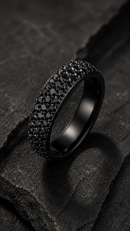 Black Diamond Wedding Rings for Men: Bold, Masculine, and Built to Last 7 Black pavé diamond men’s wedding band on dark stone surface in a dramatic moody luxury editorial close-up scene