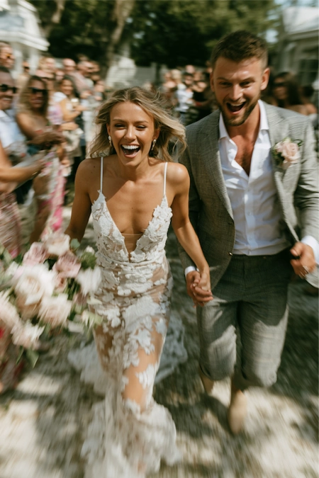 What to discuss before planning a wedding 10 Newlyweds run hand in hand through cheering guests after the ceremony, celebrating their wedding day with joy