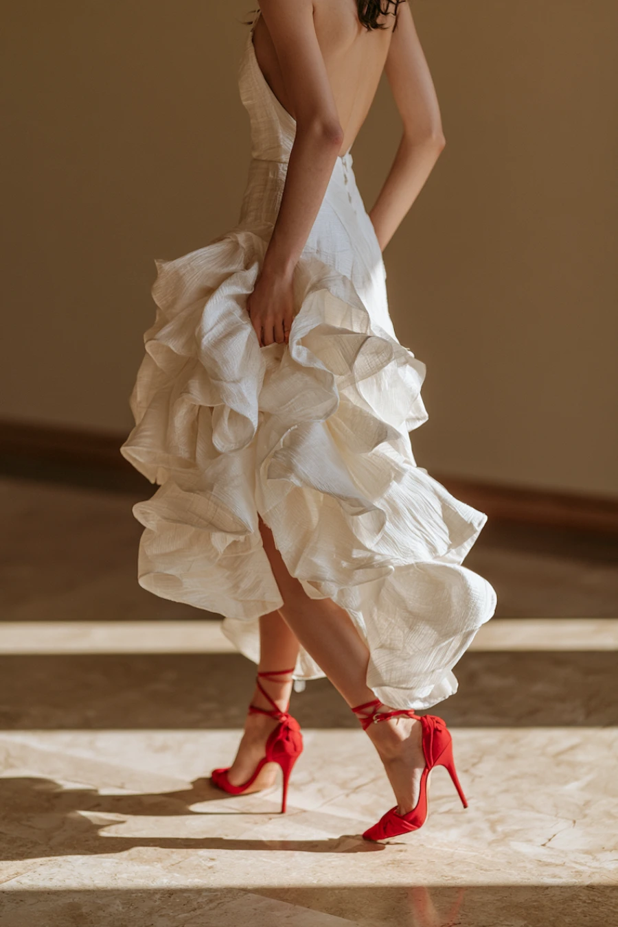 Wedding Shoes for the Bride: 27 Beautiful Ideas That Balance Style and Comfort 22 Bride in flowing ivory wedding dress wearing bold red ankle tie stilettos, creating a dramatic bridal fashion statement