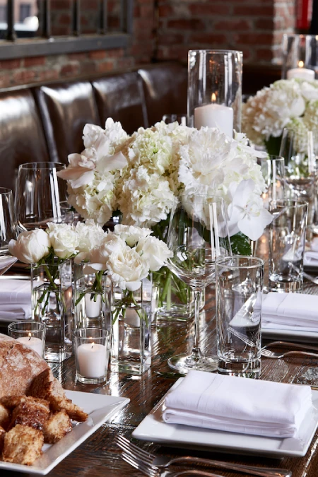 Rehearsal Dinner Centerpieces That Understood the Assignment: Easy Ideas for the Night Before the Big Night 5 Elegant rehearsal dinner table with white florals, candlelight, and private dining room ambiance