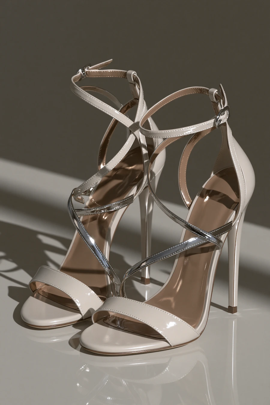 Wedding Shoes for the Bride: 27 Beautiful Ideas That Balance Style and Comfort 8 Ivory bridal sandals with metallic crossover straps, ankle buckles, and slim stiletto heels in a luxury studio setting
