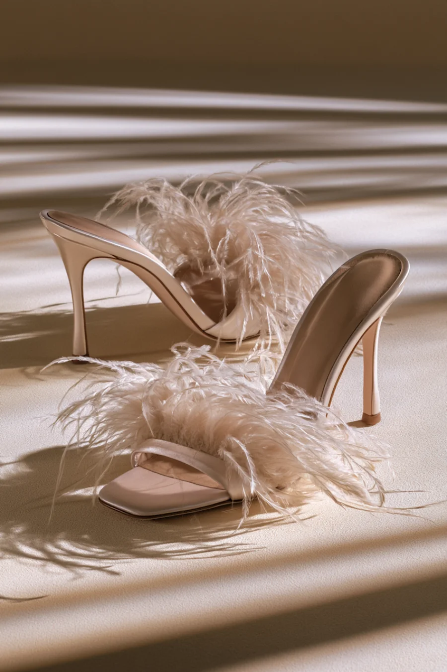 Wedding Shoes for the Bride: 27 Beautiful Ideas That Balance Style and Comfort 26 Ivory feather bridal mule heels with open square toes and slim stilettos in warm light for glamorous wedding reception style