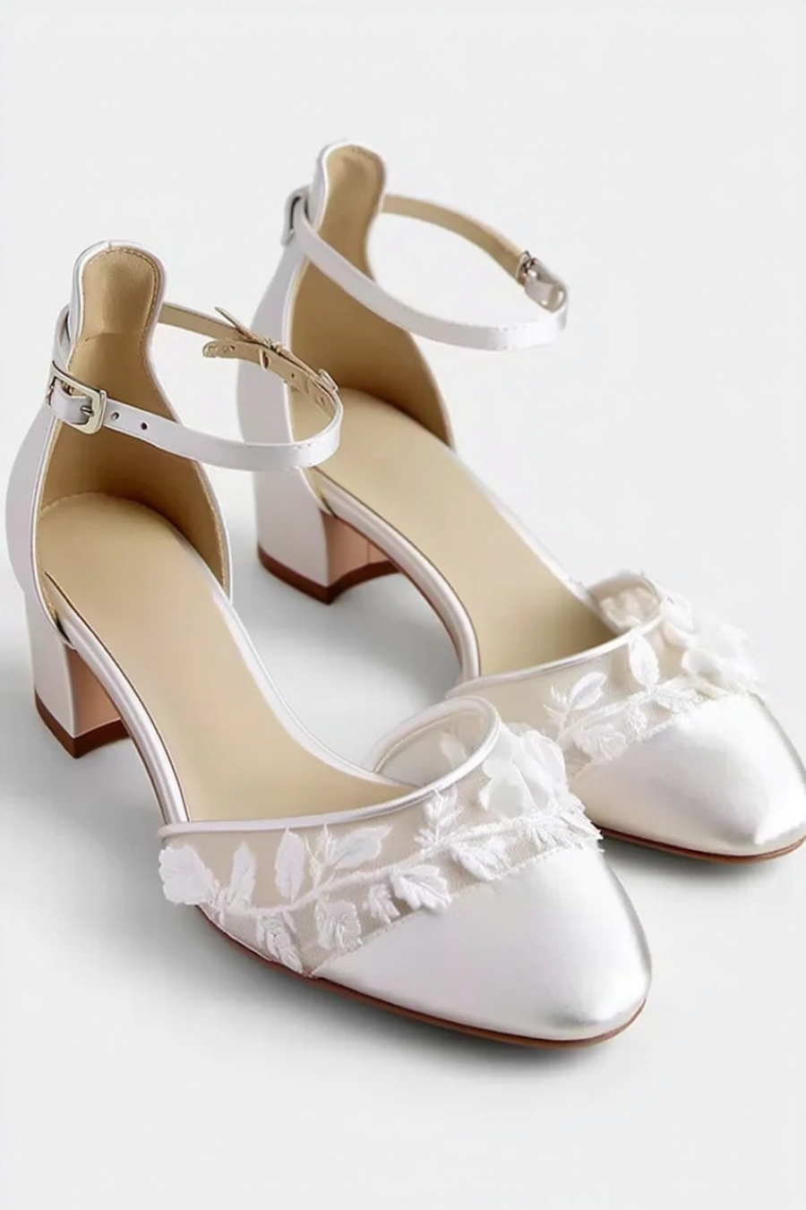 Wedding Shoes for the Bride: 27 Beautiful Ideas That Balance Style and Comfort 15 Ivory lace wedding shoes with low block heels, ankle straps, sheer floral embroidery, and pointed toes on white background