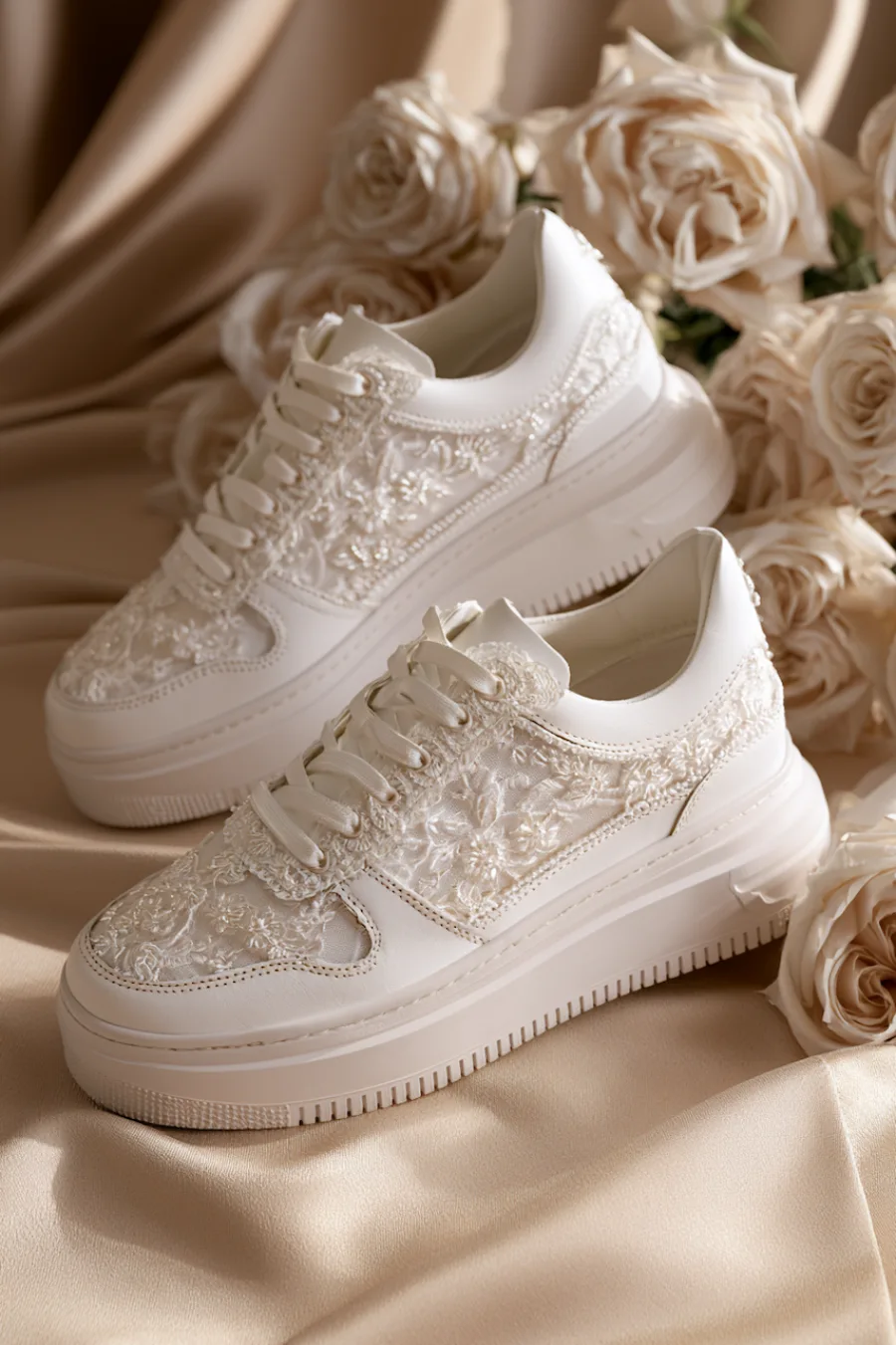 Wedding Shoes for the Bride: 27 Beautiful Ideas That Balance Style and Comfort 18 White lace bridal sneakers with floral embroidery and chunky soles styled on satin beside ivory roses for wedding day comfort